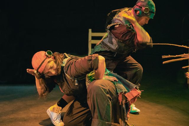 Kate Spear and Allison Blakeney mid-dance, moving like birds